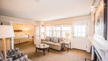 A spacious living room with a sofa set, a coffee table, and a fireplace.