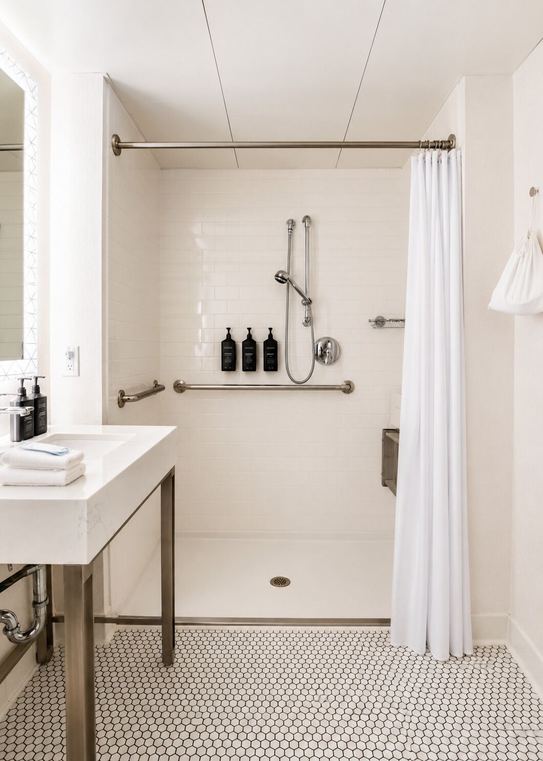 A modern bathroom with a shower, toilet, and sink.