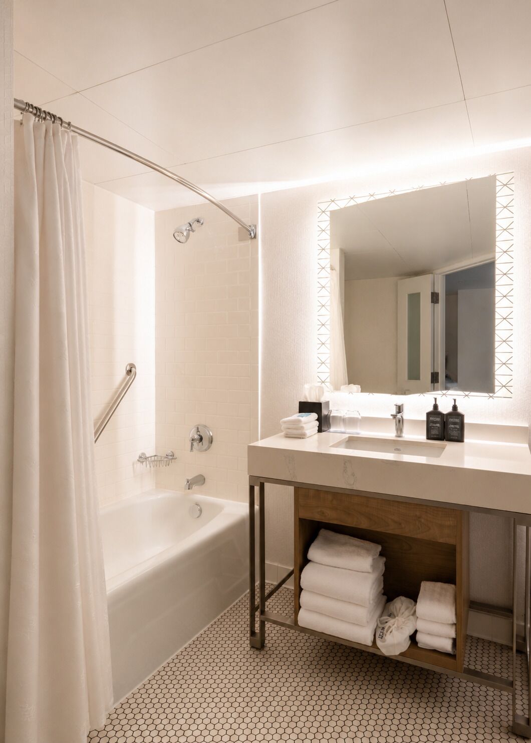 A modern bathroom with a bathtub, a vanity with a mirror, and a towel rack.