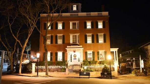 A brick building with multiple windows and a central entrance. - Jared Coffin House (Nantucket)