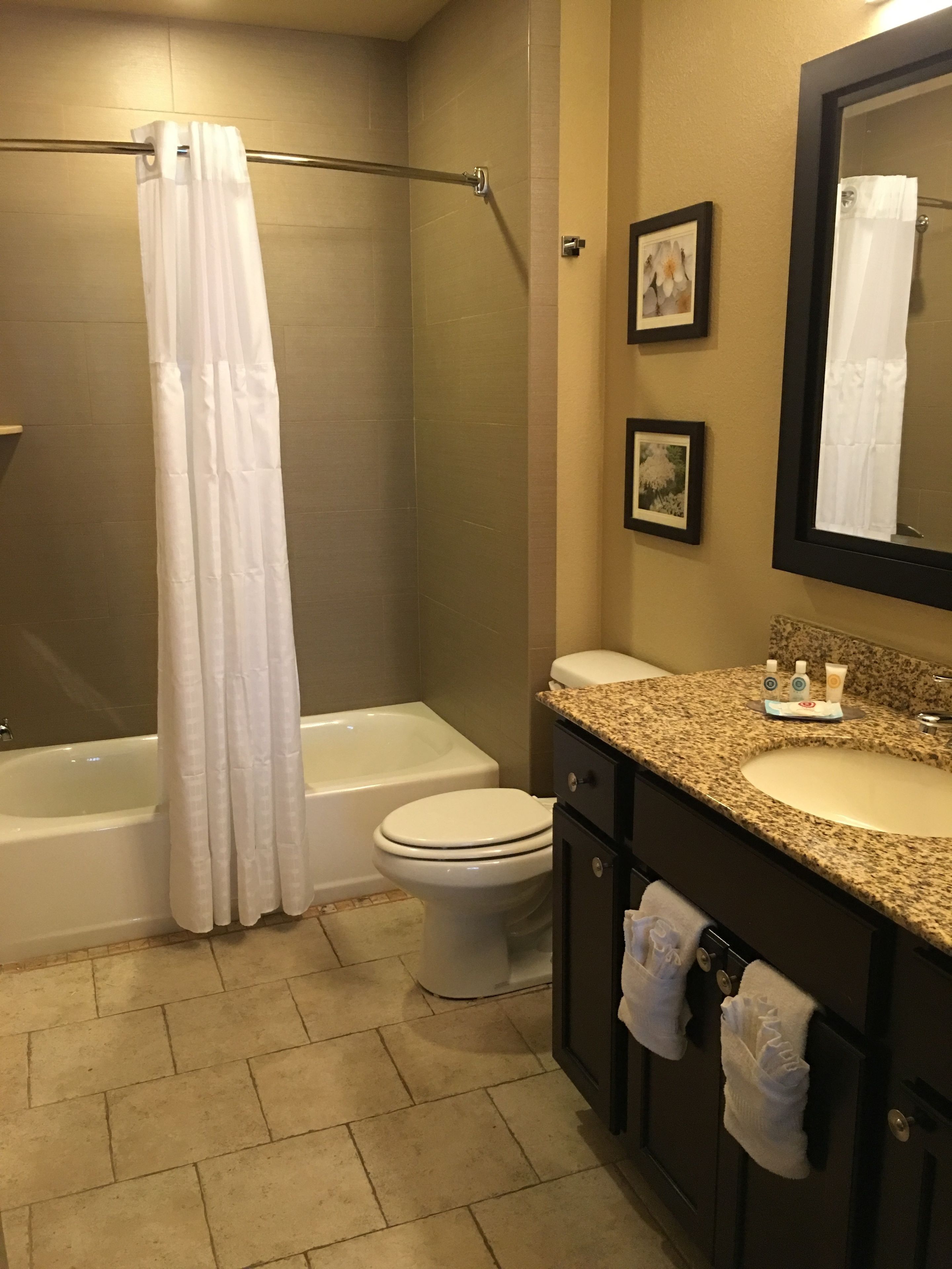 A bathroom with a bathtub, toilet, and sink.