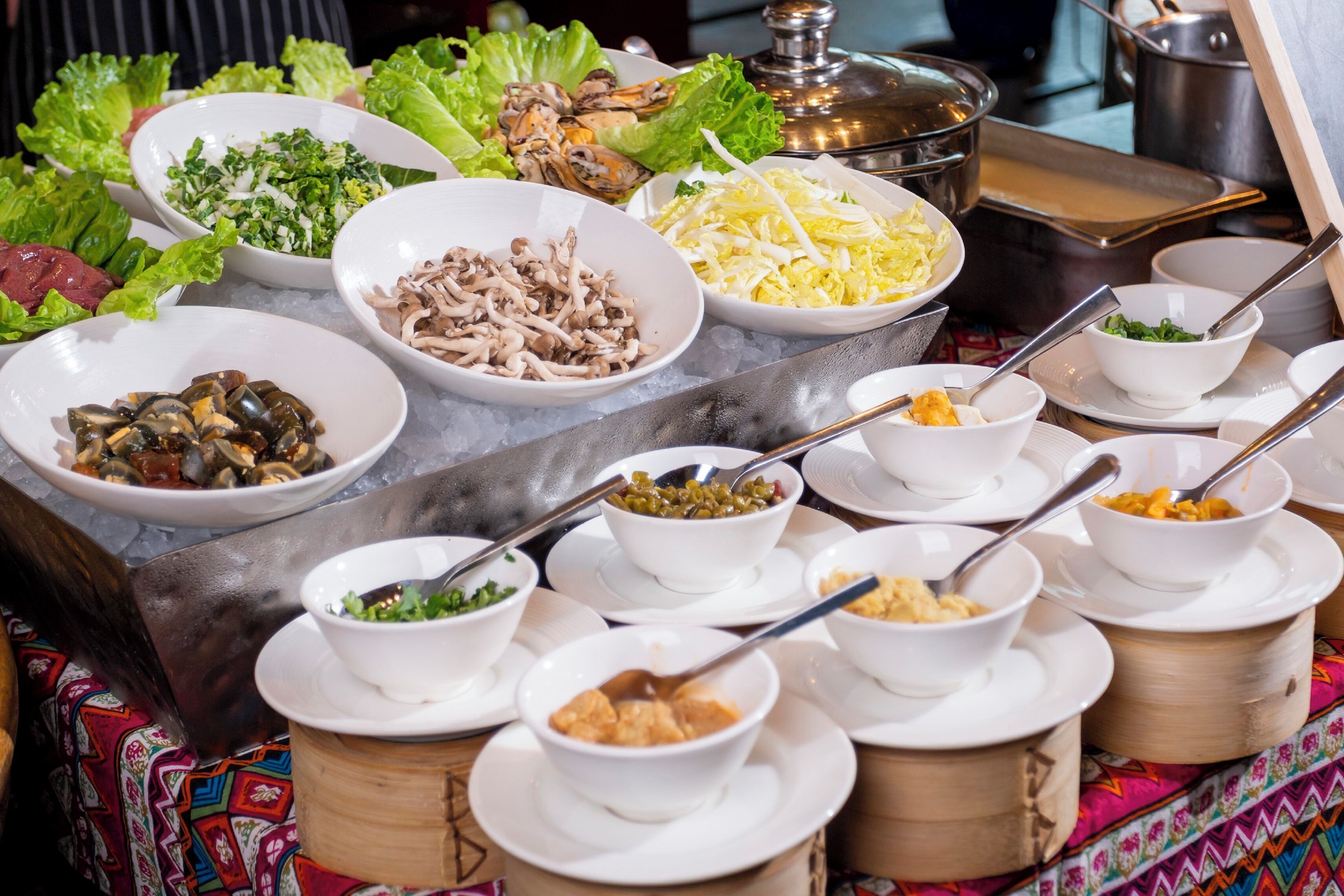 A buffet with various dishes including seafood, vegetables, and other foods.