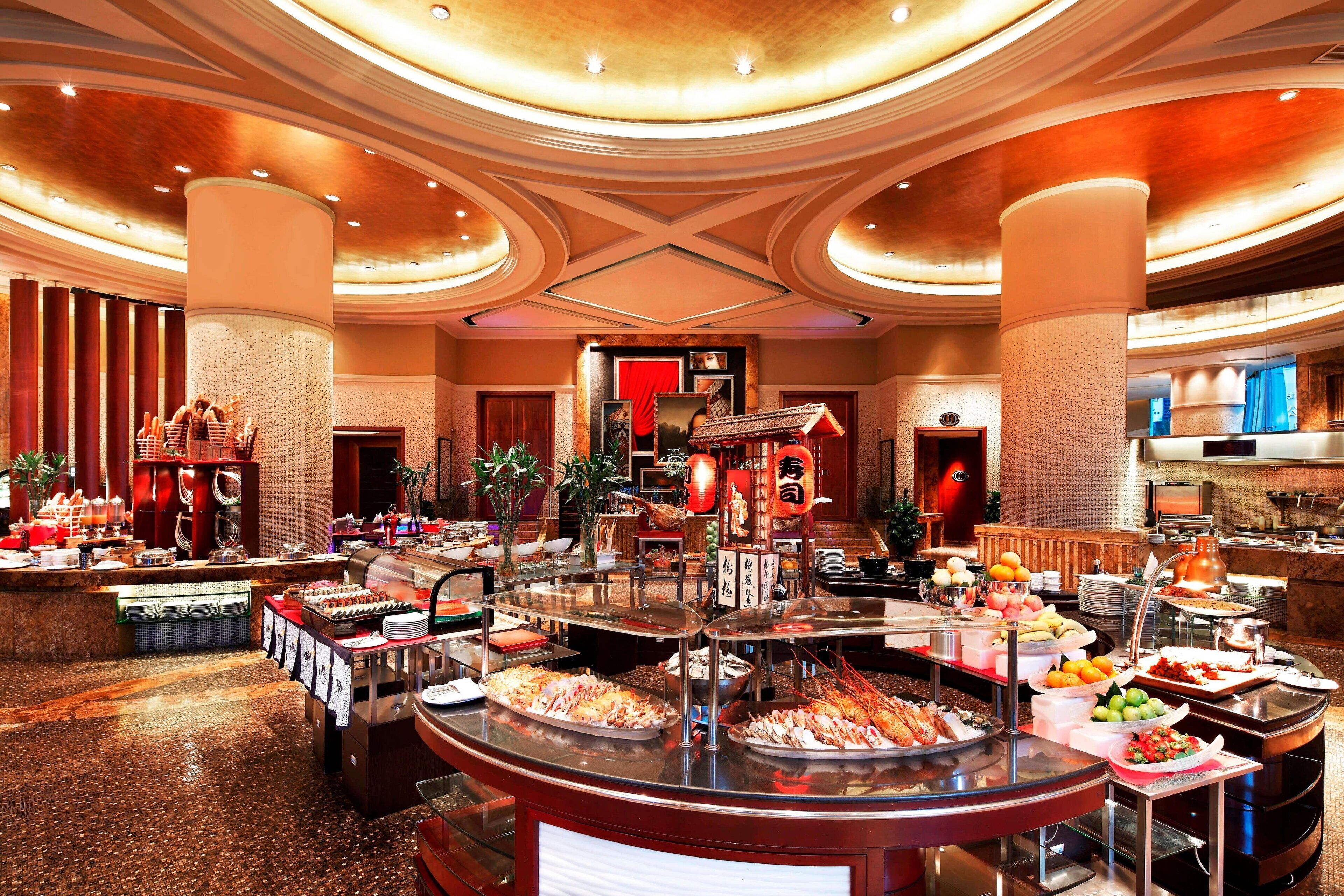 A buffet with various food items and a traditional Asian decor.