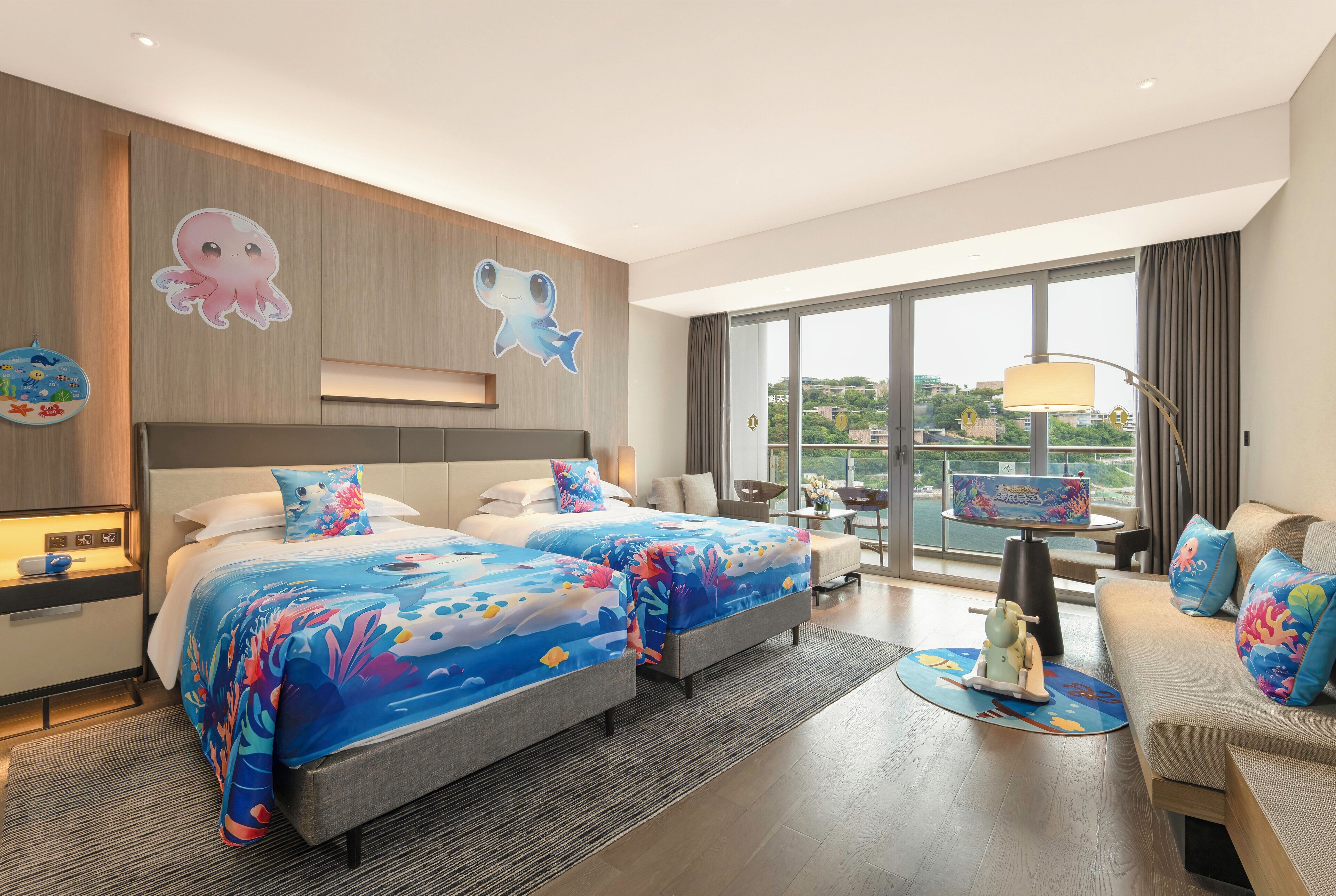 A modern hotel room with a large bed, a sofa, and a balcony with a view.