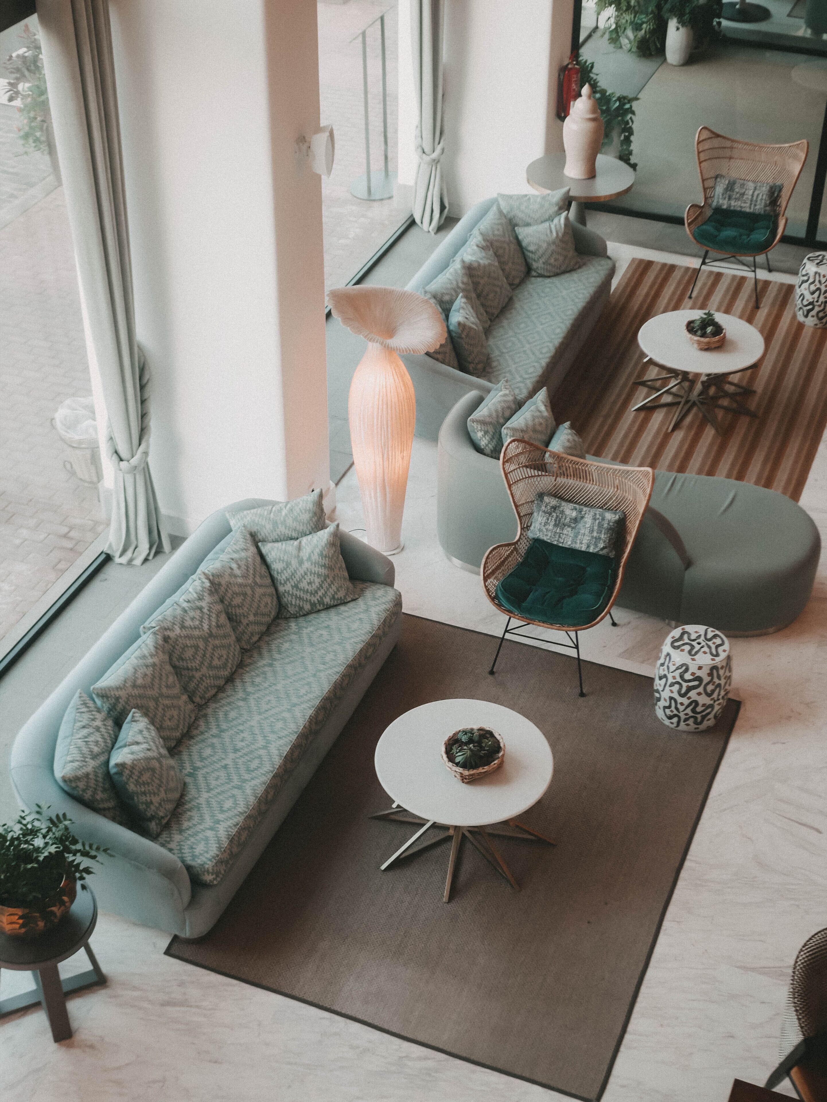 A modern living room with a sofa, chairs, a coffee table, and a floor lamp.