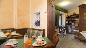 A dining area with a table set for breakfast, including croissants, fruit, and coffee. - Chateau (Saint-Pierre)