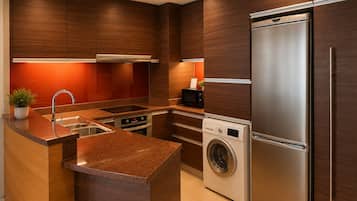 A modern kitchen with built-in appliances, a central island, and wooden cabinetry.