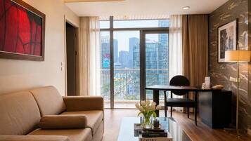 One Bedroom Executive Suite | Living area | 32-inch LCD TV with satellite channels, TV, DVD player