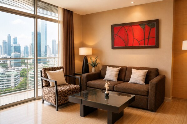 A modern hotel room with a city view, a sofa, a chair, a table, and a lamp.