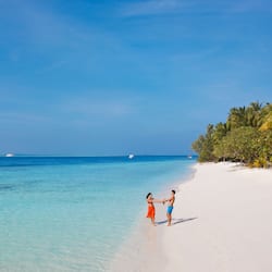 On the beach, white sand, beach towels, windsurfing