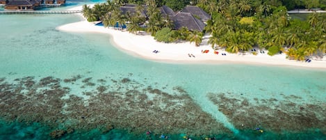 On the beach, white sand, beach towels, windsurfing