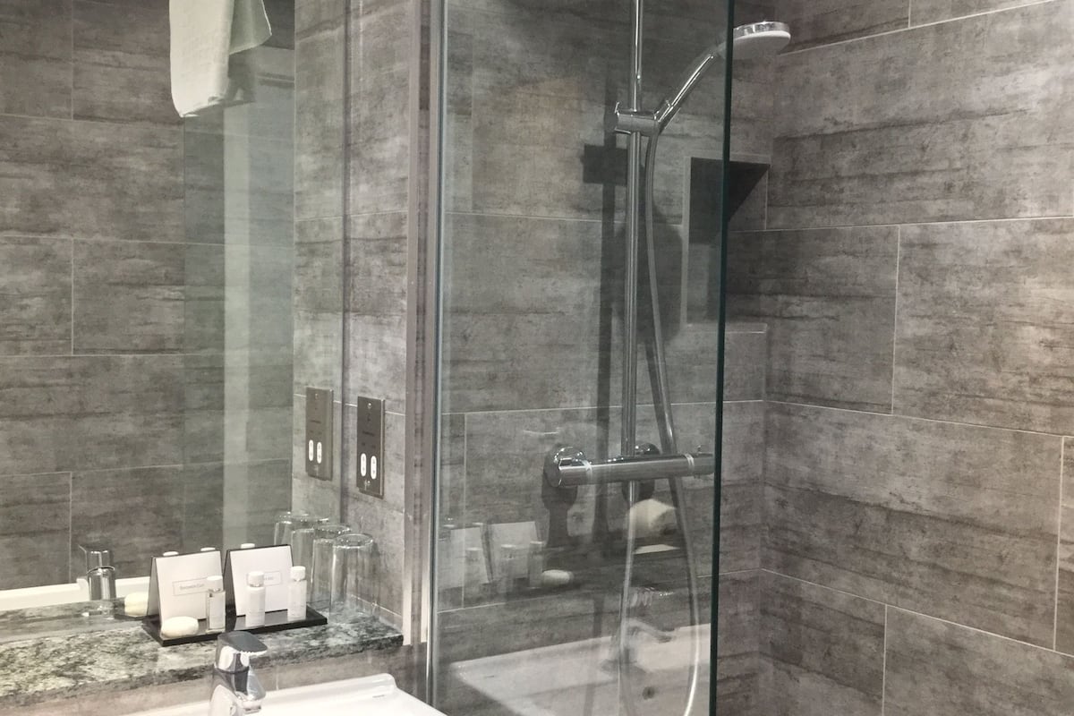 rainfall showerhead, designer toiletries, hair dryer, towels