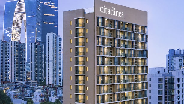 A high-rise hotel with a modern design, featuring a prominent 'Citadines' sign at the top. - Citadines Xinghai Suzhou (Suzhou)