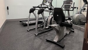 A gym with treadmills, an elliptical, and a weight machine. - Best Western Cleveland Inn & Suites (Cleveland)