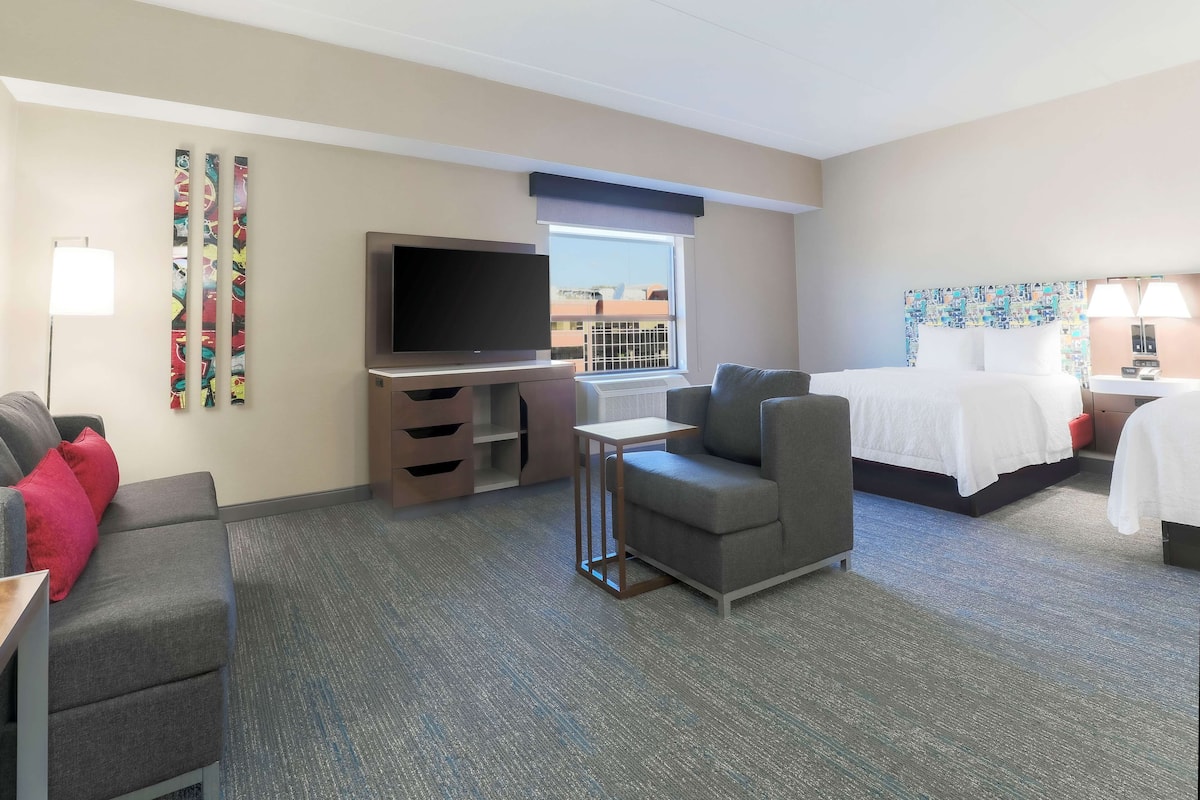 Studio Suite, 2 Queen Beds, Sofa Bed | Living area | 55-inch LCD TV with cable channels, TV