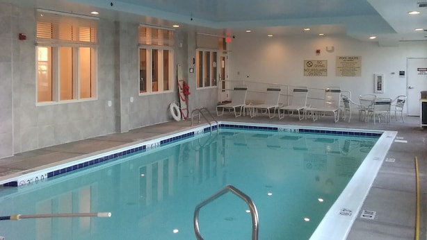 An indoor swimming pool with clear water, a lifeguard chair, and a sign indicating no diving. - Sleep Inn & Suites Laurel near Fort Meade (Laurel)