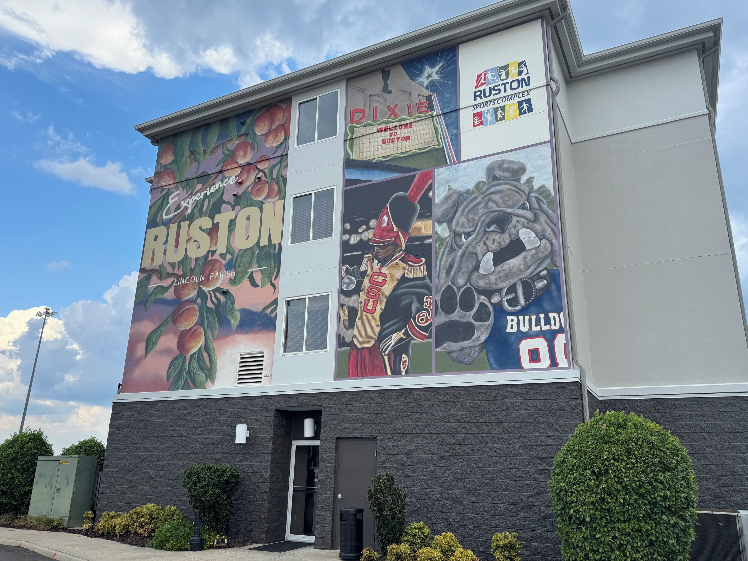 A building with a large mural advertising Ruston, featuring a football player and a bulldog.
