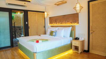 A hotel room with a bed, bedside table, and a wall-mounted artwork.