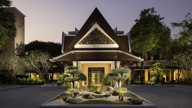 A modern building with a triangular roof and a well-maintained garden in front. - Samui Palm Beach Lead by Celes Samui (Koh Samui)