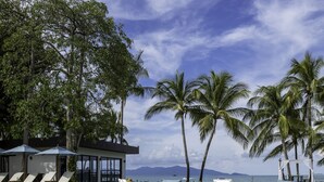 A clear blue pool with lounge chairs and umbrellas, surrounded by palm trees and a view of the ocean. - Samui Palm Beach Lead by Celes Samui (Koh Samui)