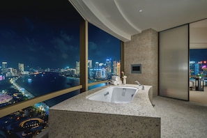 A modern bathroom with a large sink, a mirror, and a view of a cityscape at night. - Hyatt on the Bund, Shanghai (Shanghai)