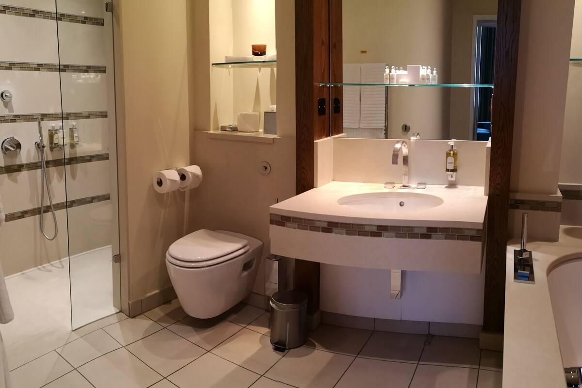 designer toiletries, hair dryer, bathrobes, slippers