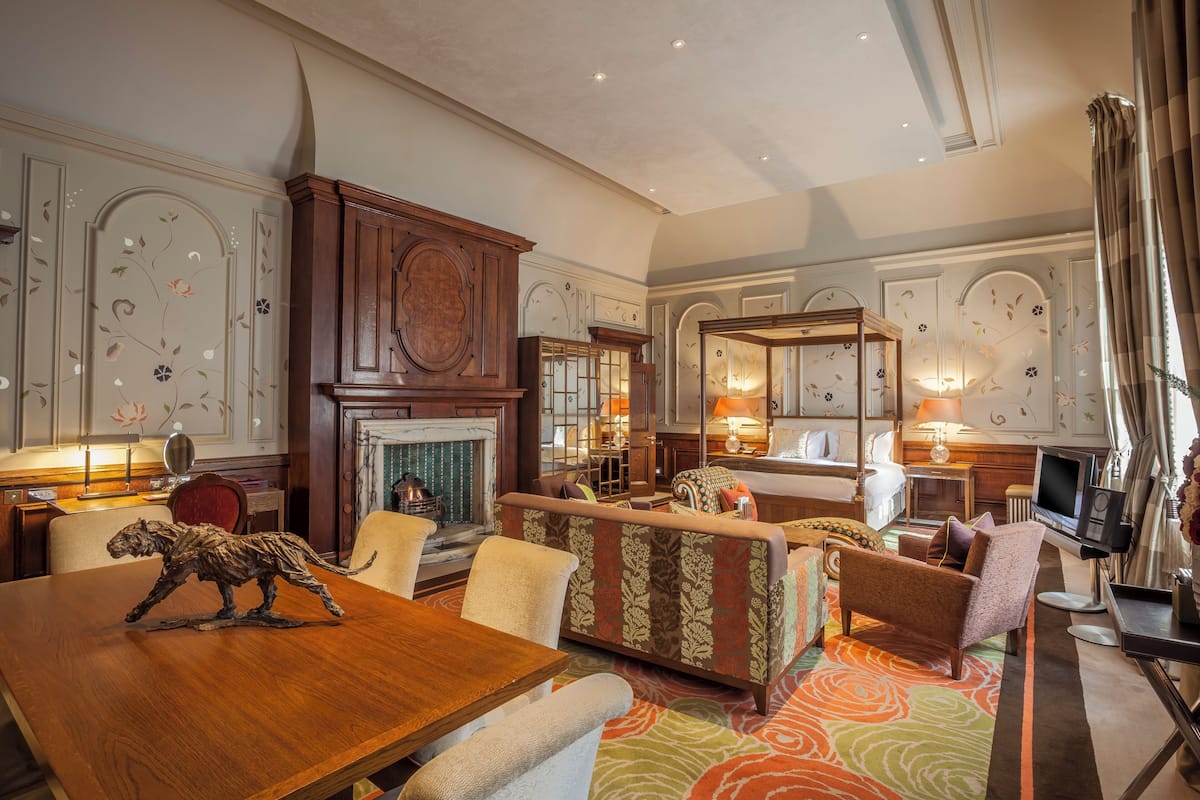 A spacious living room with a fireplace, comfortable seating, and a television.