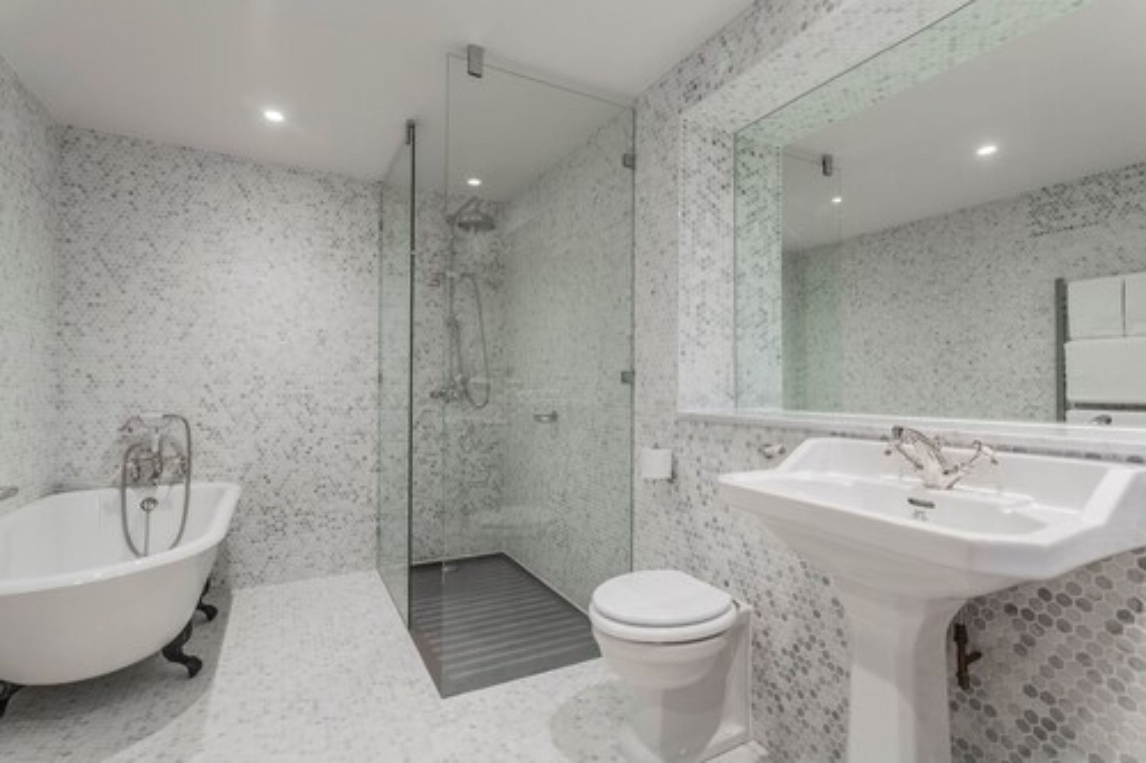 A modern bathroom with a freestanding bathtub, a sink, and a toilet.