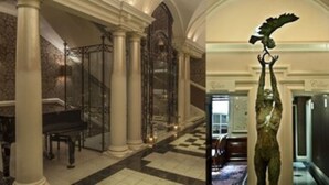 A grand lobby with marble columns, a piano, and a statue of an eagle. - The Roseate Reading (Reading)