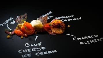 A dessert with various components labeled, including 'Blue Cheese Ice Cream' and 'Charred Clementine'.