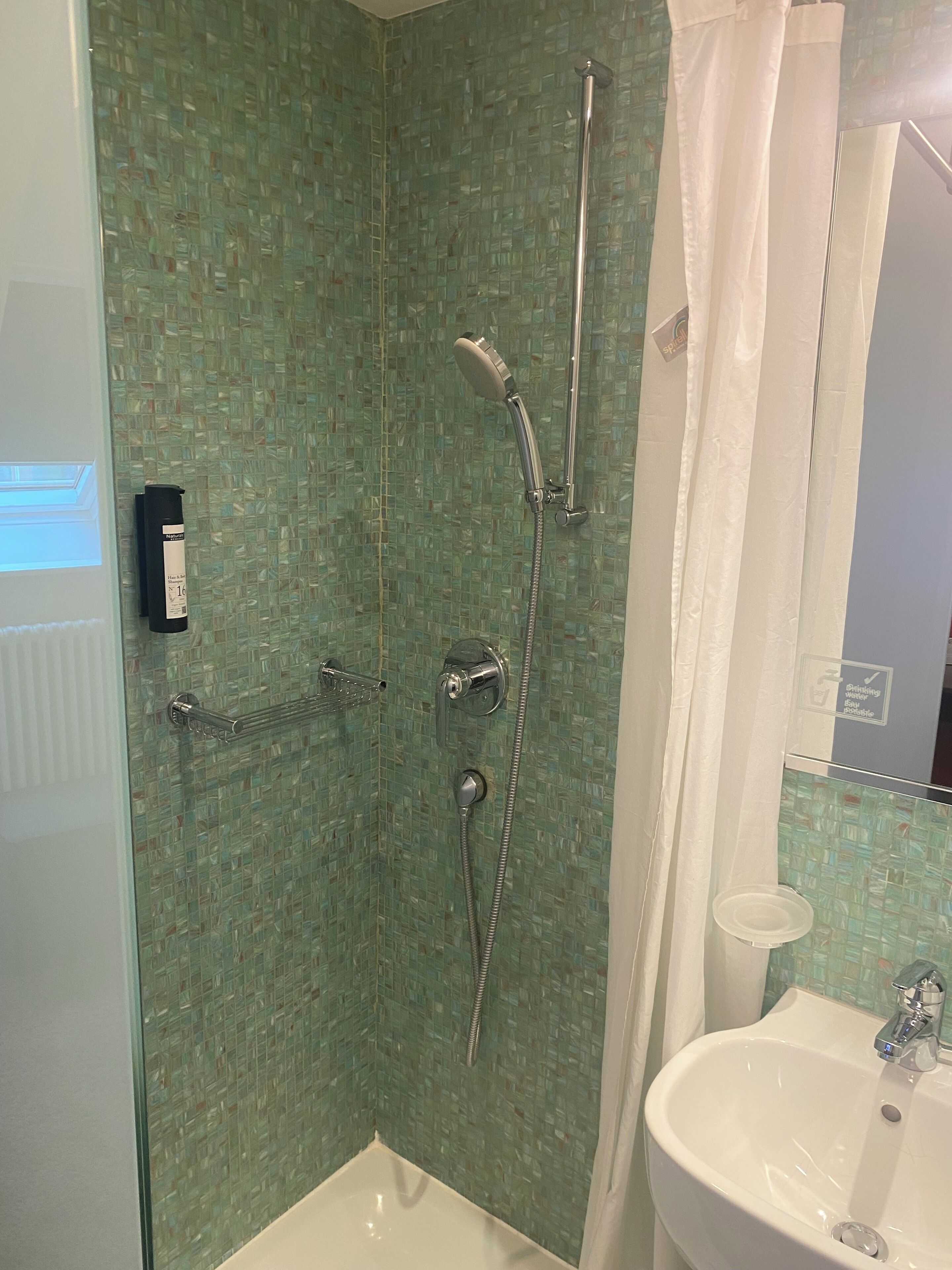 economy single room | bathroom | shower, hair dryer, towels, toilet paper