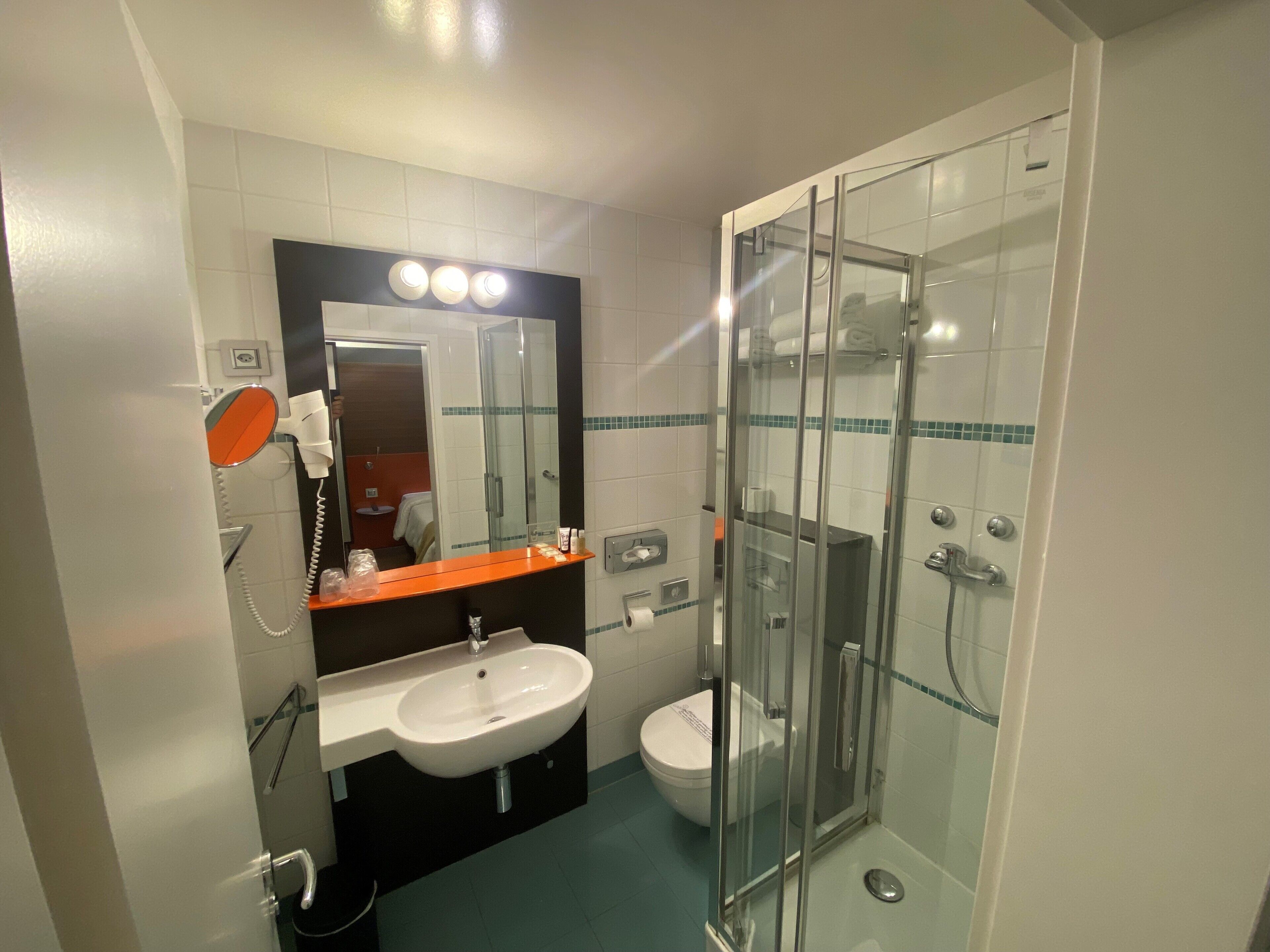 shower, hair dryer, towels, toilet paper