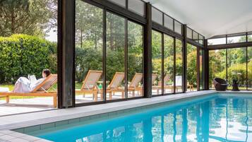 Indoor pool, open 9:00 AM to 9:00 PM, pool loungers