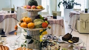 A buffet table with various food items including fruits, pastries, and bread. - Rizzi Aquacharme Hotel & Spa (Darfo Boario Terme)