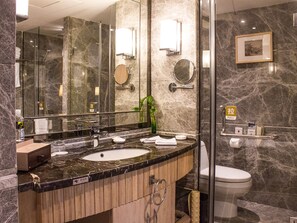 A modern bathroom with a marble sink, a glass shower enclosure, and a toilet. - Jinling Riverside Hotel Nanjing (Nanjing)