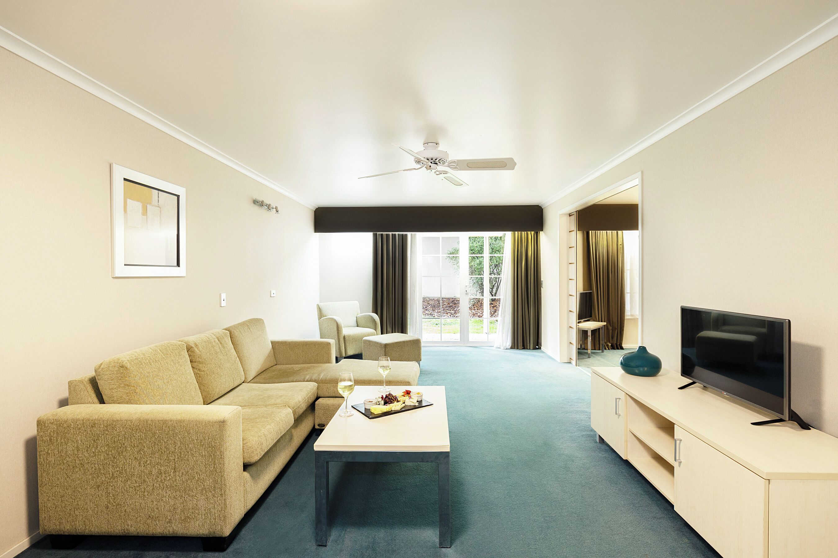 junior suite, 1 king bed | living area | 32-inch tv with cable channels