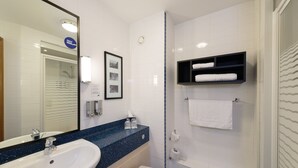 A modern bathroom with a white sink, a toilet, and a shower. There is a framed picture on the wall and a towel rack with towels. - Holiday Inn Express Birmingham Star City by IHG (Birmingham)