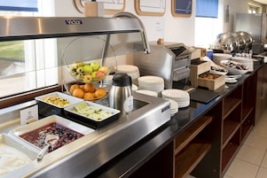 Un buffet proposant une variété de plats et un coin café.