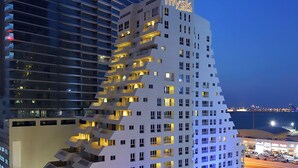 A modern hotel with multiple floors, balconies, and a prominent sign. - Mysk Al Fateh Bahrain (Manama)