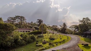 A landscaped garden with a curved pathway, benches, and a gazebo.