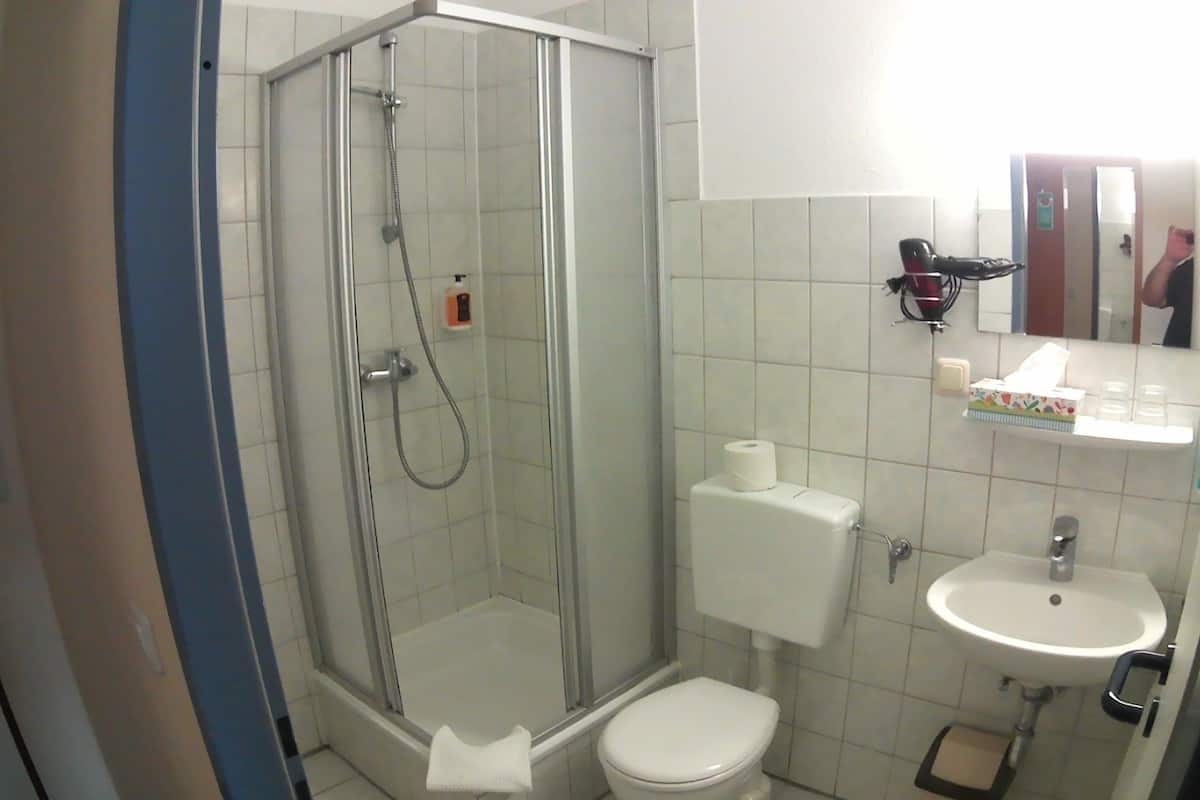 standard double room | bathroom | shower, hair dryer, towels