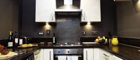 Fridge, microwave, coffee/tea maker, cookware/dishes/utensils