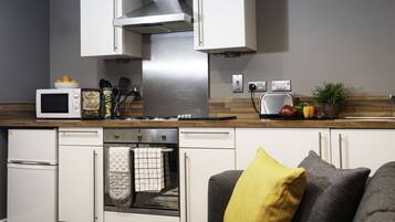 Fridge, microwave, coffee/tea maker, cookware/dishes/utensils