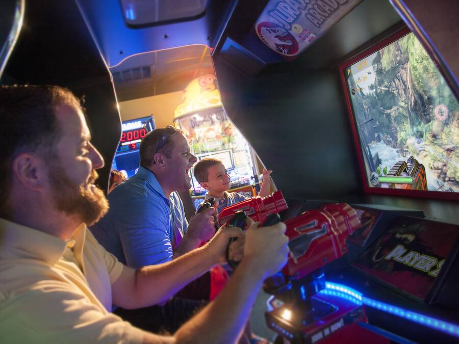 People playing a video game in an arcade setting.