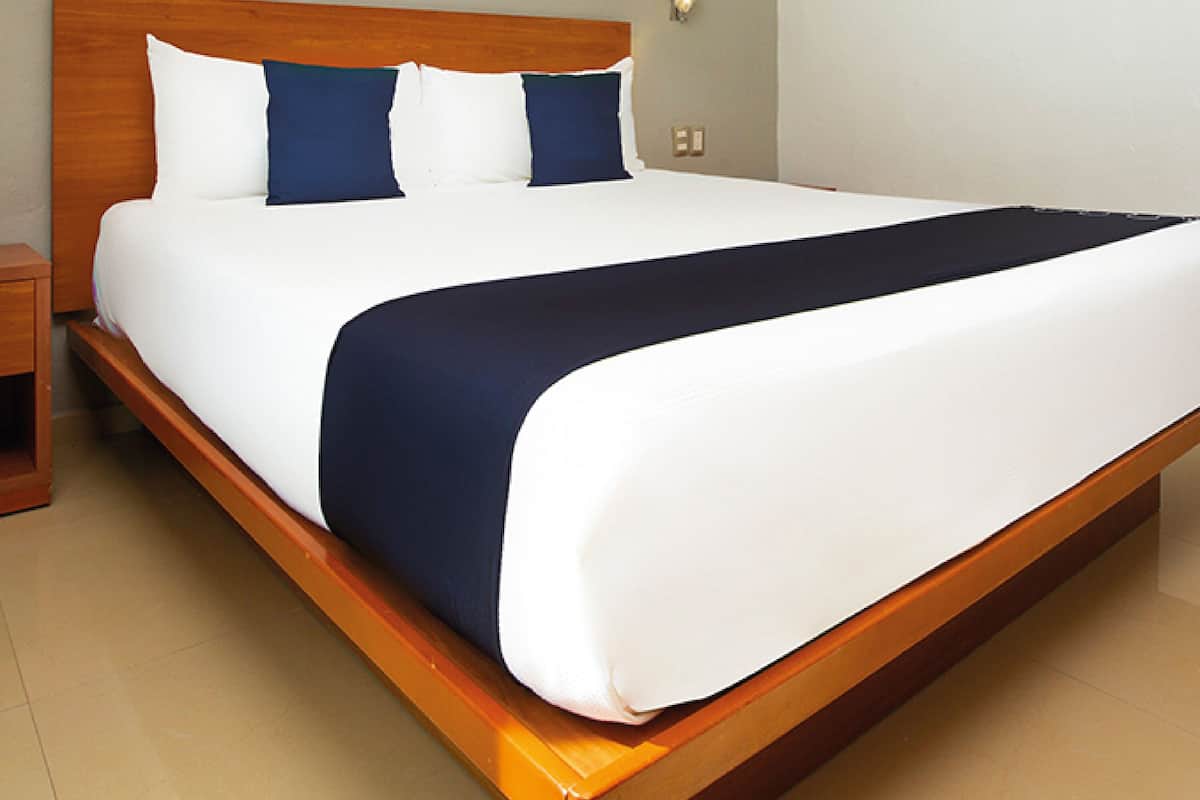 Premium bedding, desk, laptop workspace, blackout drapes