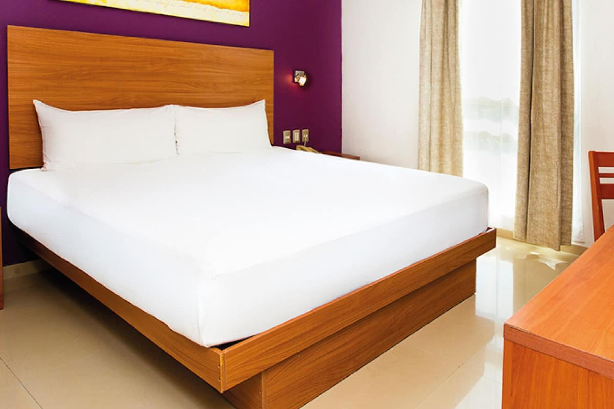 Premium bedding, desk, laptop workspace, blackout drapes