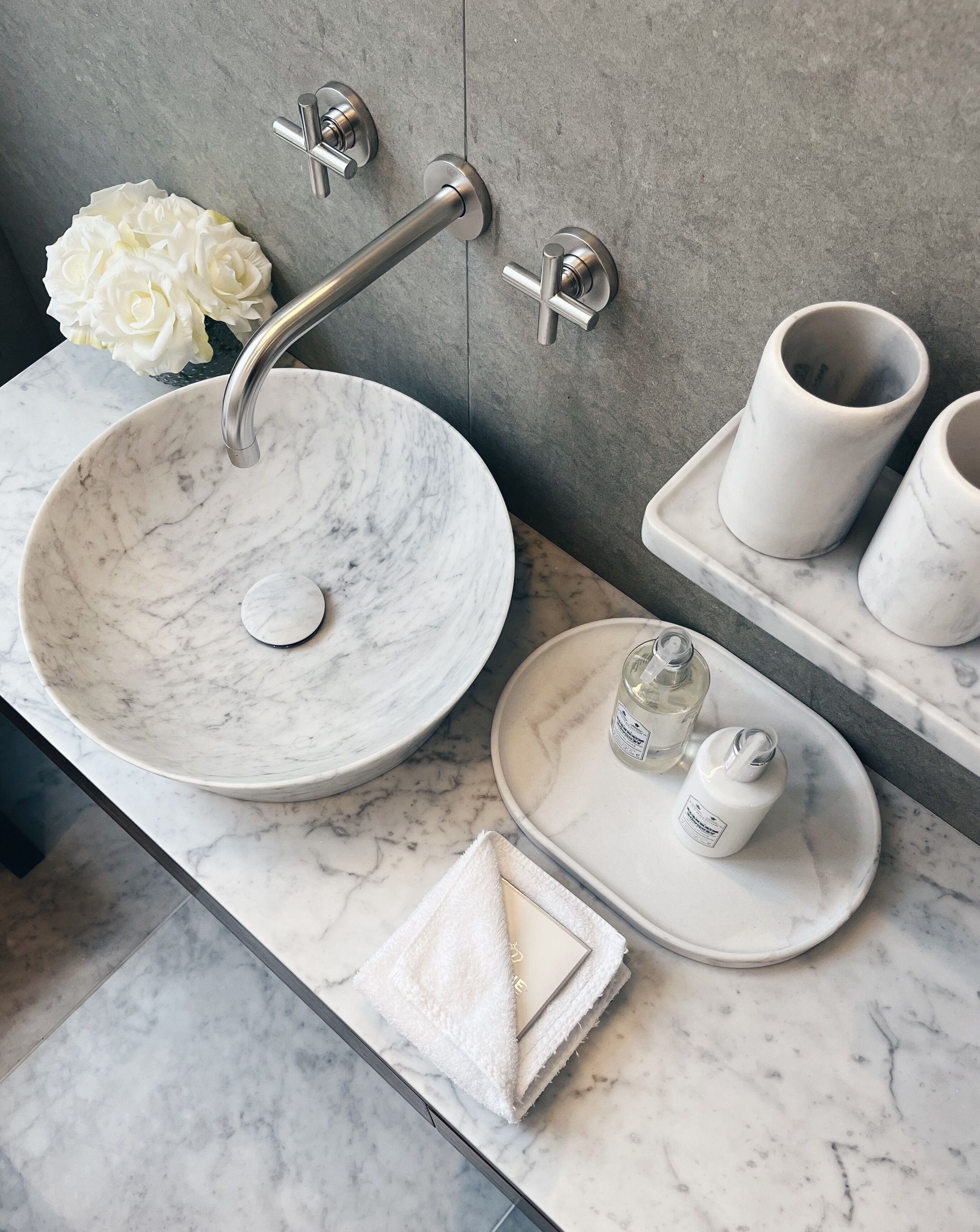 designer toiletries, hair dryer, slippers, towels