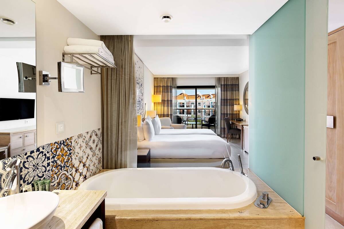deluxe room, 1 king bed | bathroom | separate bathtub and shower, free toiletries, hair dryer, bathrobes