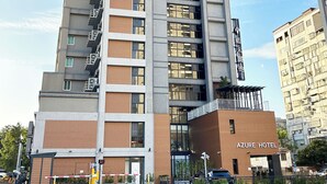 A multi-story hotel with a modern design, featuring balconies and a prominent signage for the Azure Hotel. - Azure Hotel (Hualien City)
