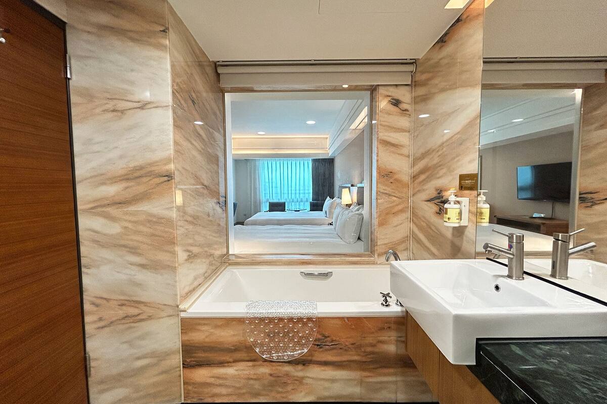 deluxe family room | bathroom | hair dryer, towels, shampoo, toilet paper
